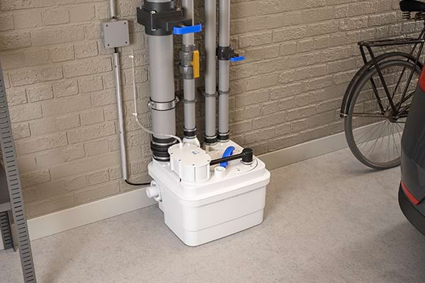 The Sanicubic 1 lifting station installed in a bathroom in the basement